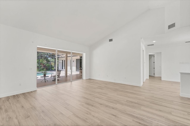 2914 Dick Wilson Dr, Sarasota, FL 34240 - spare room with high vaulted ceiling, light wood finished floors, and baseboards