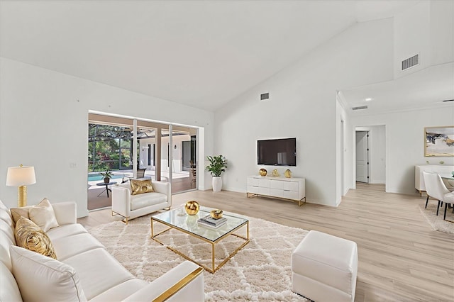 2914 Dick Wilson Dr, Sarasota, FL 34240 - living area with high vaulted ceiling, light wood finished floors, and baseboards