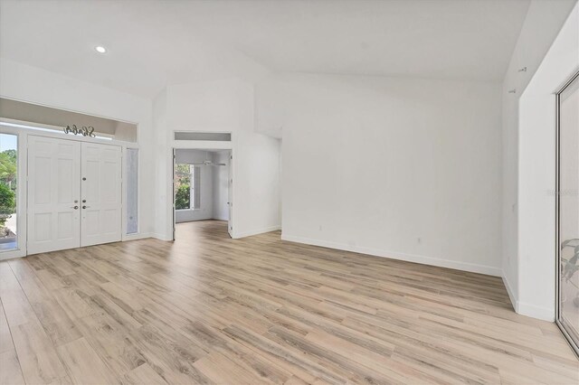 2914 Dick Wilson Dr, Sarasota, FL 34240 - entryway with vaulted ceiling, light wood-style flooring, baseboards, and recessed lighting