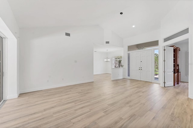 2914 Dick Wilson Dr, Sarasota, FL 34240 - foyer with high vaulted ceiling, light wood-style flooring, baseboards, and a chandelier