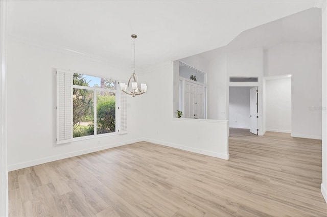 2914 Dick Wilson Dr, Sarasota, FL 34240 - spare room featuring a chandelier, light wood-style floors, baseboards, and vaulted ceiling