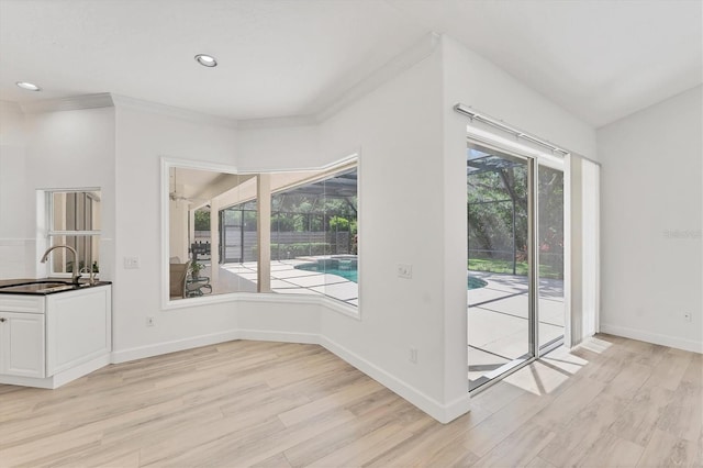 2914 Dick Wilson Dr, Sarasota, FL 34240 - unfurnished dining area featuring a sink, light wood-style floors, baseboards, recessed lighting, and ornamental molding