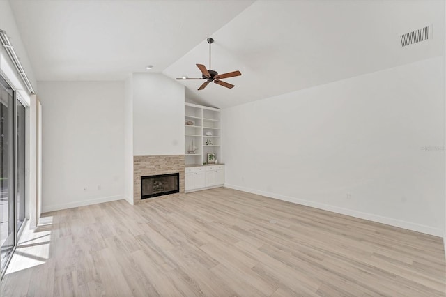 2914 Dick Wilson Dr, Sarasota, FL 34240 - unfurnished living room with a glass covered fireplace, light wood-style flooring, vaulted ceiling, ceiling fan, and built in features