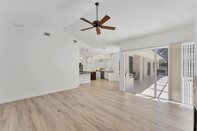 2914 Dick Wilson Dr, Sarasota, FL 34240 - unfurnished living room with a ceiling fan, light wood-type flooring, a sink, french doors, and high vaulted ceiling