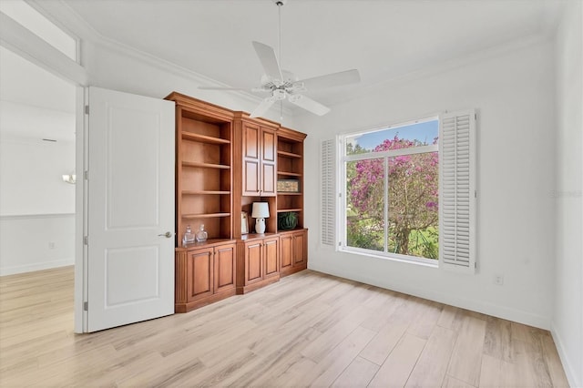 2914 Dick Wilson Dr, Sarasota, FL 34240 - empty room with light wood finished floors, ceiling fan, baseboards, and crown molding