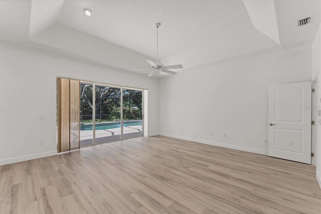 2914 Dick Wilson Dr, Sarasota, FL 34240 - empty room featuring ceiling fan, a tray ceiling, light wood-style floors, baseboards, and recessed lighting