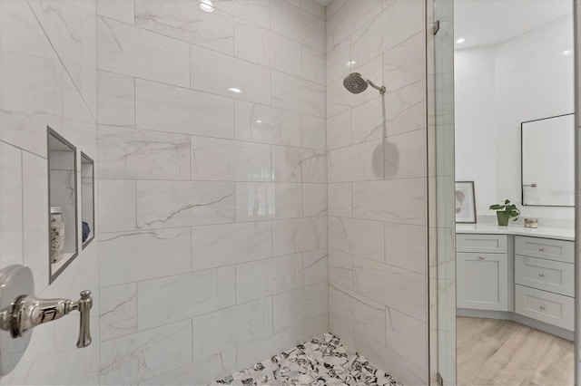 2914 Dick Wilson Dr, Sarasota, FL 34240 - bathroom featuring tiled shower, vanity, and wood finished floors