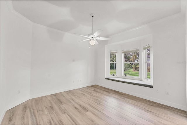 2914 Dick Wilson Dr, Sarasota, FL 34240 - empty room with light wood finished floors, baseboards, ceiling fan, and ornamental molding