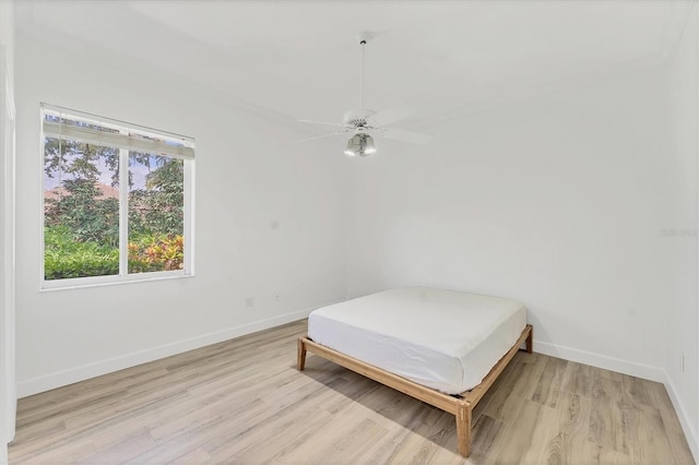2914 Dick Wilson Dr, Sarasota, FL 34240 - bedroom with light wood-style floors, baseboards, and ceiling fan