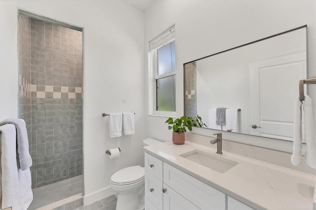 2914 Dick Wilson Dr, Sarasota, FL 34240 - bathroom with vanity, a tile shower, toilet, tile patterned flooring, and baseboards