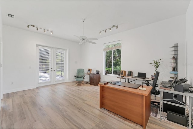 2914 Dick Wilson Dr, Sarasota, FL 34240 - home office featuring track lighting, french doors, and wood finished floors