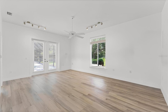 2914 Dick Wilson Dr, Sarasota, FL 34240 - spare room featuring track lighting, french doors, and light wood-style flooring