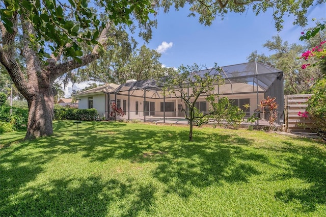 2914 Dick Wilson Dr, Sarasota, FL 34240 - back of property with a yard, stucco siding, and a lanai