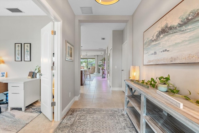 12327 Halfmoon Lake Ter, Bradenton, FL 34211 - hallway featuring light tile patterned floors and baseboards