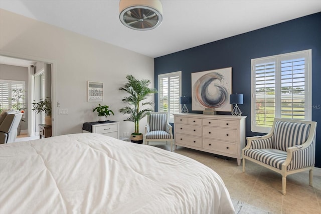 12327 Halfmoon Lake Ter, Bradenton, FL 34211 - bedroom with light tile patterned flooring and an accent wall