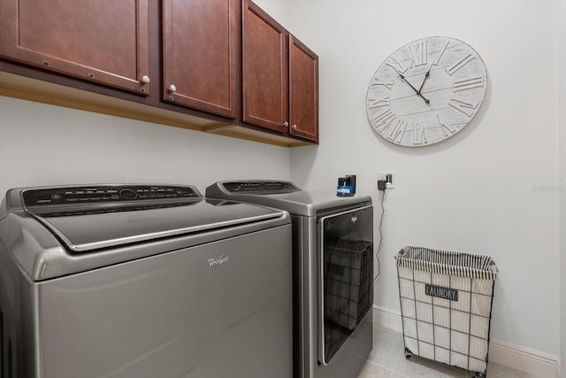 12327 Halfmoon Lake Ter, Bradenton, FL 34211 - washroom with cabinet space, washer and clothes dryer, and light tile patterned floors