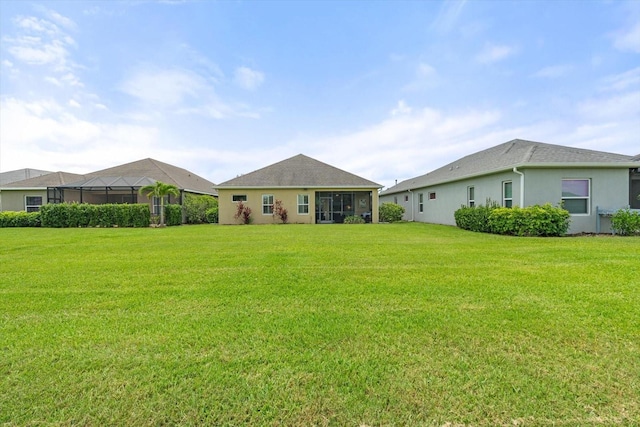 12327 Halfmoon Lake Ter, Bradenton, FL 34211 - rear view of house featuring a yard and stucco siding