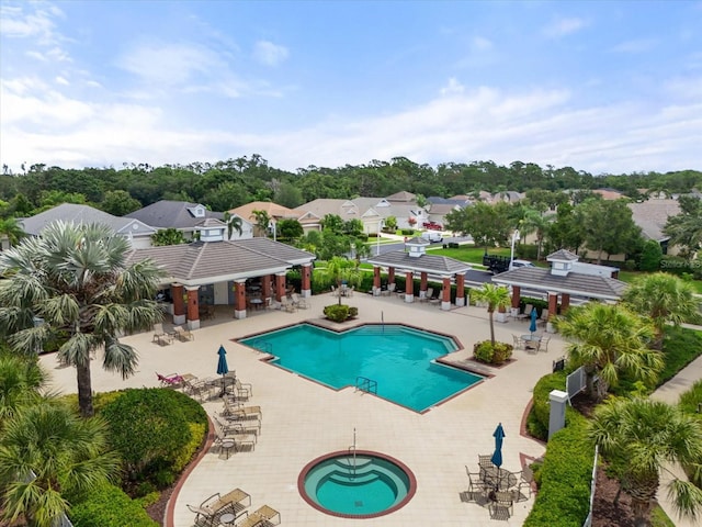 12327 Halfmoon Lake Ter, Bradenton, FL 34211 - community pool featuring a hot tub, a patio, a pergola, and a residential view