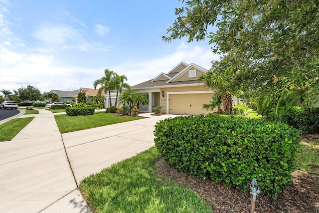 12327 Halfmoon Lake Ter, Bradenton, FL 34211 - view of front of house featuring a garage, concrete driveway, and a front lawn