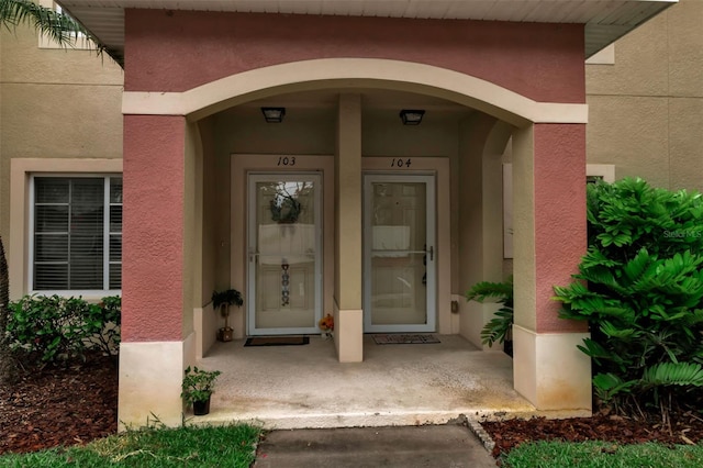 3707 45th Ter W Unit 104, Bradenton, FL 34210 - view of exterior entry featuring stucco siding and covered porch