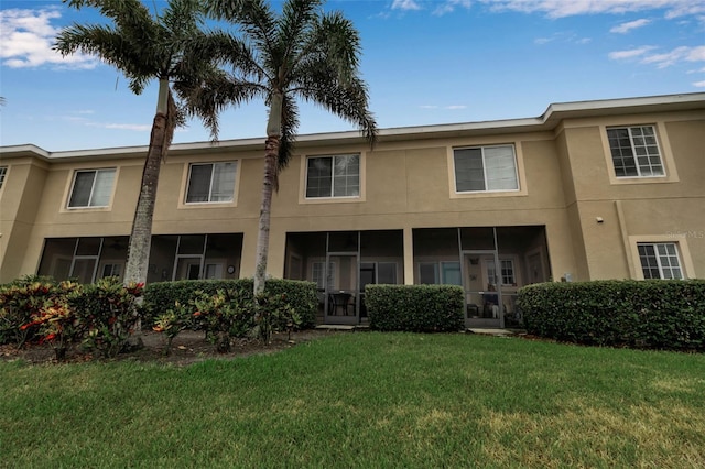 3707 45th Ter W Unit 104, Bradenton, FL 34210 - rear view of property featuring stucco siding and a yard