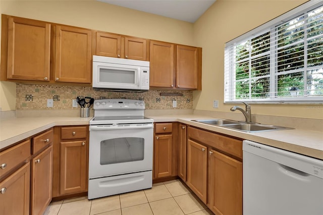 3707 45th Ter W Unit 104, Bradenton, FL 34210 - kitchen featuring white appliances, a sink, decorative backsplash, and light countertops
