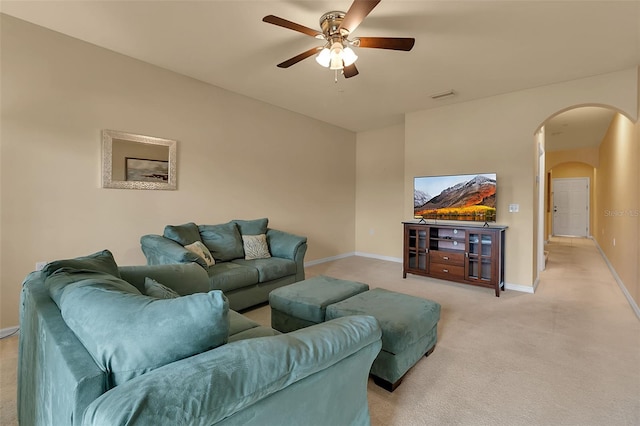 3707 45th Ter W Unit 104, Bradenton, FL 34210 - living room featuring arched walkways, baseboards, a ceiling fan, and light colored carpet