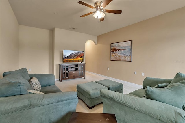 3707 45th Ter W Unit 104, Bradenton, FL 34210 - living room featuring light carpet, ceiling fan, arched walkways, and baseboards