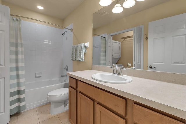 3707 45th Ter W Unit 104, Bradenton, FL 34210 - bathroom with stacked washer / drying machine, tile patterned floors, vanity, toilet, and shower / bathtub combination with curtain