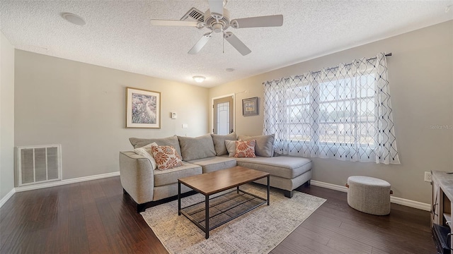 4611 Spahn St, Sarasota, FL 34232 - living area featuring a textured ceiling, ceiling fan, baseboards, and dark wood-style flooring