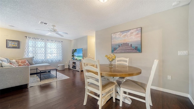 4611 Spahn St, Sarasota, FL 34232 - dining space featuring a textured ceiling, dark wood-style floors, a ceiling fan, and baseboards