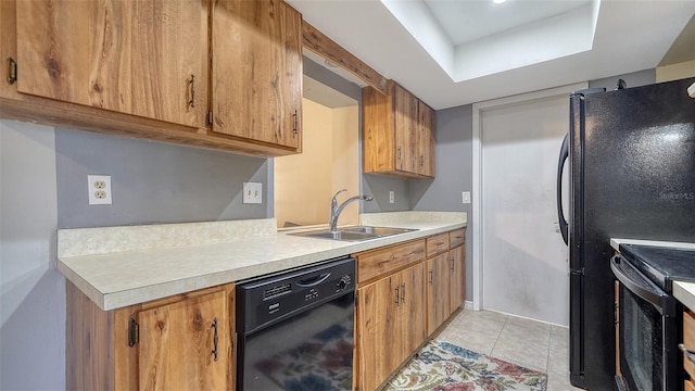 4611 Spahn St, Sarasota, FL 34232 - kitchen featuring black appliances, a sink, light countertops, light tile patterned floors, and brown cabinetry