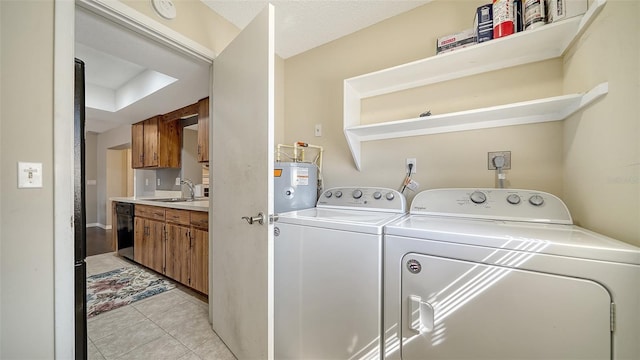 4611 Spahn St, Sarasota, FL 34232 - laundry room featuring washer and dryer, light tile patterned floors, and electric water heater