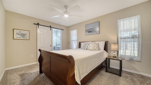 4611 Spahn St, Sarasota, FL 34232 - bedroom with carpet floors, a barn door, baseboards, and ensuite bath