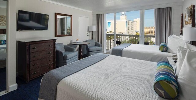 5500 Gulf Blvd Unit 6248, Saint Petersburg, FL 33706 - bedroom with access to outside, ornamental molding, and a city view