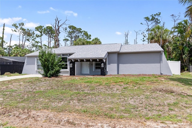 16834 Toledo Blade Blvd, Port Charlotte, FL 33954 - view of front of home with central AC unit, roof with shingles, and stucco siding