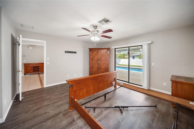 16834 Toledo Blade Blvd, Port Charlotte, FL 33954 - bedroom featuring access to outside, baseboards, wood finished floors, and ceiling fan