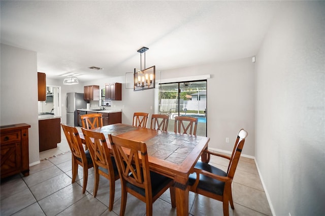 16834 Toledo Blade Blvd, Port Charlotte, FL 33954 - dining room featuring a chandelier and light tile patterned floors