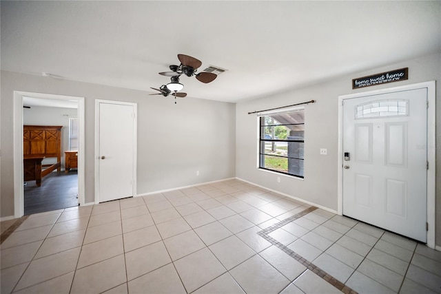16834 Toledo Blade Blvd, Port Charlotte, FL 33954 - entrance foyer with light tile patterned flooring, ceiling fan, and baseboards
