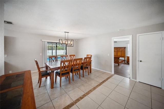 16834 Toledo Blade Blvd, Port Charlotte, FL 33954 - dining room featuring baseboards, light tile patterned flooring, a chandelier, and inlaid floor details
