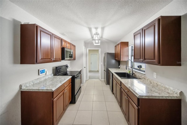 16834 Toledo Blade Blvd, Port Charlotte, FL 33954 - kitchen with appliances with stainless steel finishes, a sink, light countertops, light tile patterned floors, and a textured ceiling