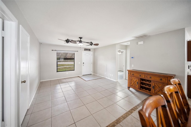 16834 Toledo Blade Blvd, Port Charlotte, FL 33954 - unfurnished living room featuring a ceiling fan, light tile patterned floors, and baseboards