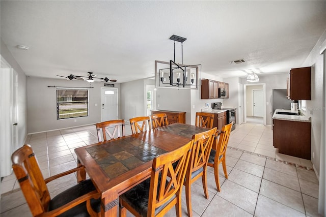 16834 Toledo Blade Blvd, Port Charlotte, FL 33954 - dining space featuring light tile patterned flooring, a ceiling fan, baseboards, and a chandelier