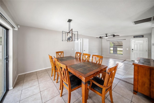 16834 Toledo Blade Blvd, Port Charlotte, FL 33954 - dining room with light tile patterned floors, a chandelier, ceiling fan, and baseboards