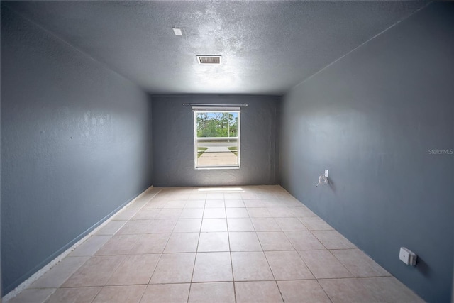 16834 Toledo Blade Blvd, Port Charlotte, FL 33954 - unfurnished room with a textured ceiling and tile patterned flooring