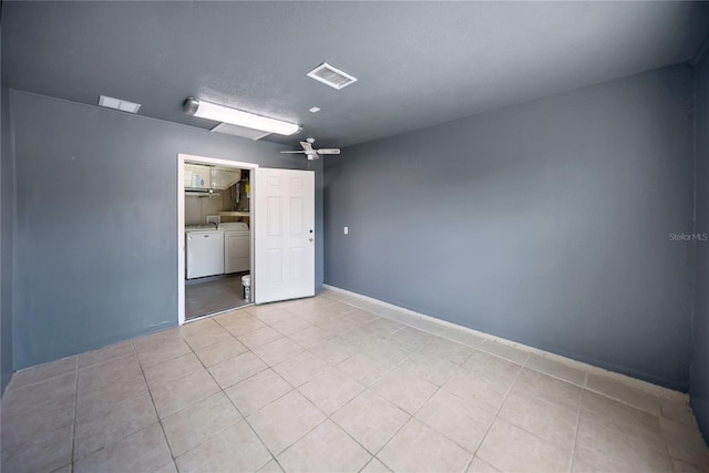 16834 Toledo Blade Blvd, Port Charlotte, FL 33954 - unfurnished bedroom with separate washer and dryer, light tile patterned floors, a closet, and ceiling fan