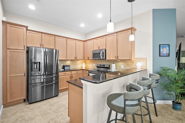5866 Guarino Dr, Sarasota, FL 34238 - kitchen with appliances with stainless steel finishes, a kitchen breakfast bar, a peninsula, backsplash, and recessed lighting