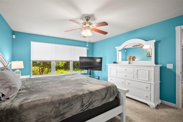 5866 Guarino Dr, Sarasota, FL 34238 - bedroom with light carpet, baseboards, and ceiling fan