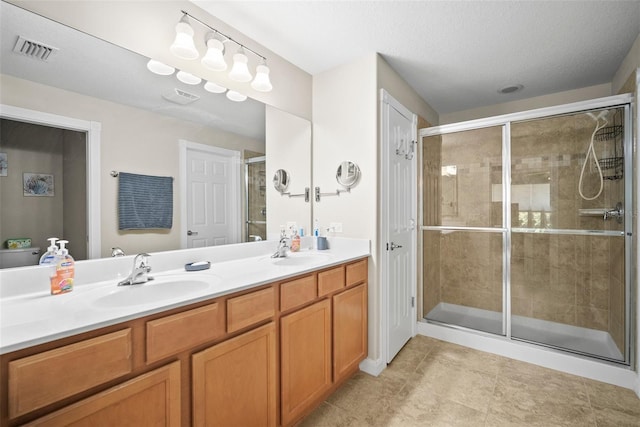 5866 Guarino Dr, Sarasota, FL 34238 - bathroom featuring double vanity, a shower stall, and tile patterned flooring