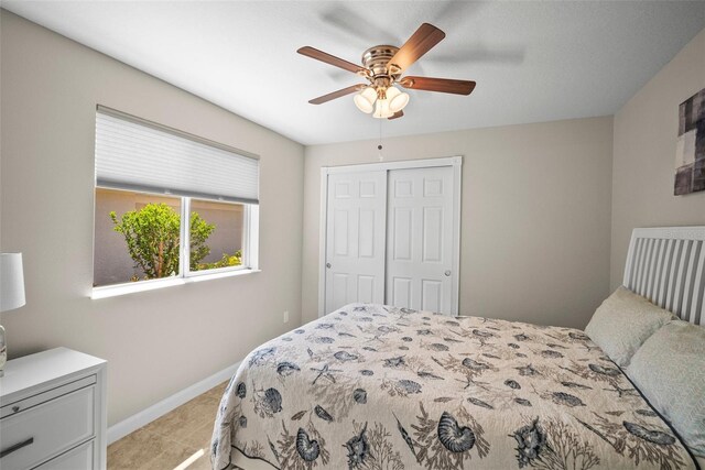 5866 Guarino Dr, Sarasota, FL 34238 - bedroom with a closet, baseboards, ceiling fan, and light carpet
